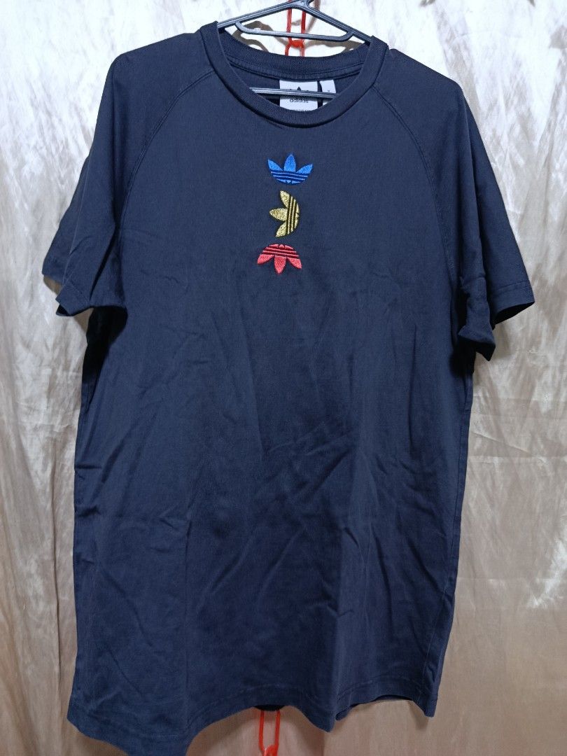 Adidas T-Shirt Size M (Category: Tshirts & Polo Shirts ) located in Jasaan. Submitted by eliwhomp (Listing ID 1449278861, Image 1). Description: - Navy blue Adidas t-shirt - Size: Medium (M) - Front: Stacked Adidas logo in various colors - Back: Repeating Adidas logo pattern - Material: 100% Cotton - 21 × 29.
