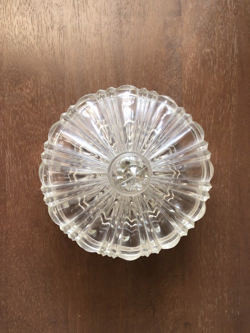 Anchor Hocking Clear Glass Candy Dish with Lid (Category: Other Kitchenware & Tableware) located in Pasig City. Submitted by vintagely (Listing ID 1449216018, Image 3). Description: - Beautiful clear glass candy dish with lid. - Features a lovely ribbed design on the lid. - Starburst pattern on the base. - Great for storing sweets or as a decorative piece. - Adds a classic touch to any table. - Measures approximately 7” inches in diameter and 51/