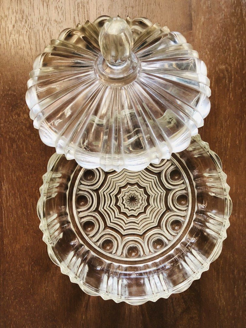 Anchor Hocking Clear Glass Candy Dish with Lid (Category: Other Kitchenware & Tableware) located in Pasig City. Submitted by vintagely (Listing ID 1449216018, Image 1). Description: - Beautiful clear glass candy dish with lid. - Features a lovely ribbed design on the lid. - Starburst pattern on the base. - Great for storing sweets or as a decorative piece. - Adds a classic touch to any table. - Measures approximately 7” inches in diameter and 51/