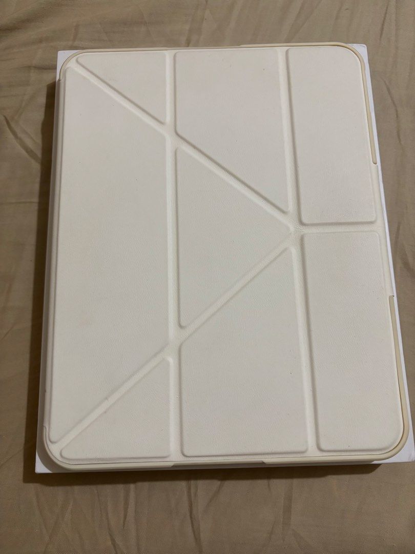 Anti-fall case for ipad 10th/11th Gen (A16) (Category: Cases & Sleeves) located in Dagupan City. Submitted by selle.ann (Listing ID 1449279803, Image 1). Description: - Cream-colored folio style iPad case - Offers multiple viewing angles for convenience - Provides protection against everyday wear and tear - Sleek and stylish design.