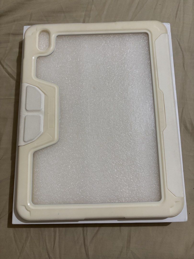 Anti-fall case for ipad 10th/11th Gen (A16) (Category: Cases & Sleeves) located in Dagupan City. Submitted by selle.ann (Listing ID 1449279803, Image 2). Description: - Cream-colored folio style iPad case - Offers multiple viewing angles for convenience - Provides protection against everyday wear and tear - Sleek and stylish design.