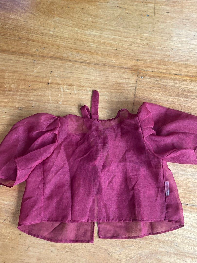 Artisanat Sheer Red Tie-Back Blouse XS (Category: Blouses) located in Makati City. Submitted by jmieiii (Listing ID 1449134774, Image 2). Description: - Sheer berry-colored blouse - Brand: Artisanat - Size: XS - Features: Puff sleeves, tie-back closure - Material: Lightweight, flowy fabric - Origin: Made in the Philippines - Versatile: Great for layering or wearing alone.