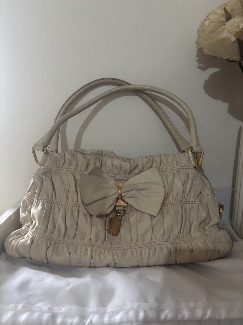 Authentic Prada Nappa Gaufre Bow Shoulder Bag (Category: Luxury Bags & Wallets) located in Manila. Submitted by shopmistash (Listing ID 1449266009, Image 2). Description: PRICE IS FIXED , will not reply to low ballers Selling my 100% authentic Prada Nappa Gaufre Bow Shoulder Bag in a timeless off-white (cream) shade. ⚠️ grabEx or meet up only due to item being of high value One of Prada’s most recognizable designs from the late 2000s to early 201