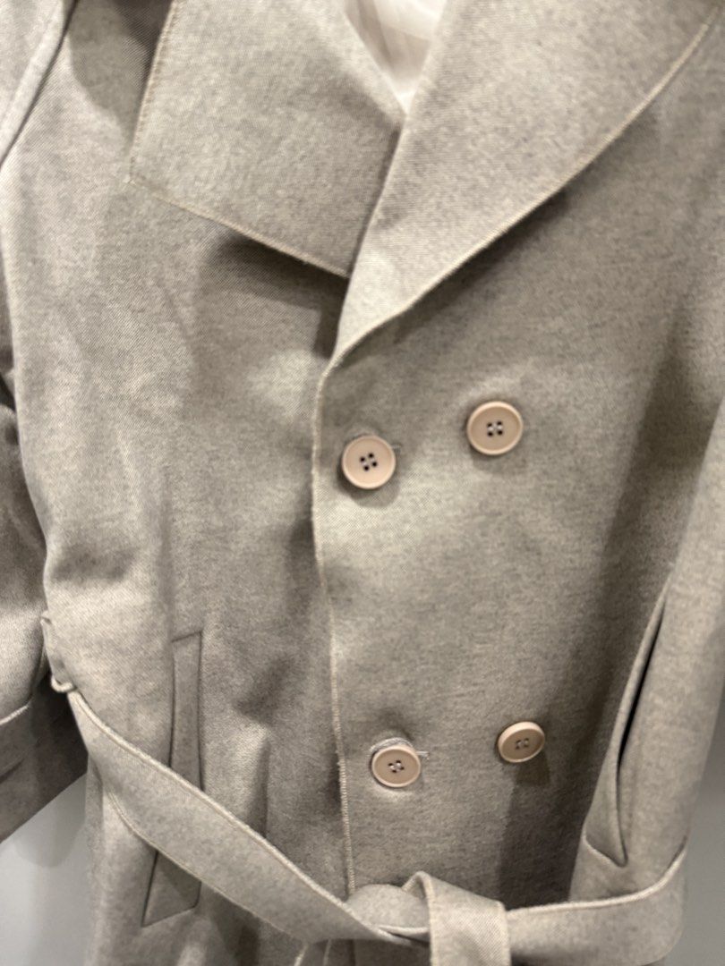 Beige Double-Breasted Trench Coat with Belt (Category: Coats, Jackets and Outerwear) located in Pasig City. Submitted by atbp__ (Listing ID 1449304056, Image 3). Description: - Classic beige trench coat from OiaoYifang - Double-breasted design - Includes matching belt - Epaulets on shoulders - Adjustable straps on cuffs - Lined interior - Ideal for layering.