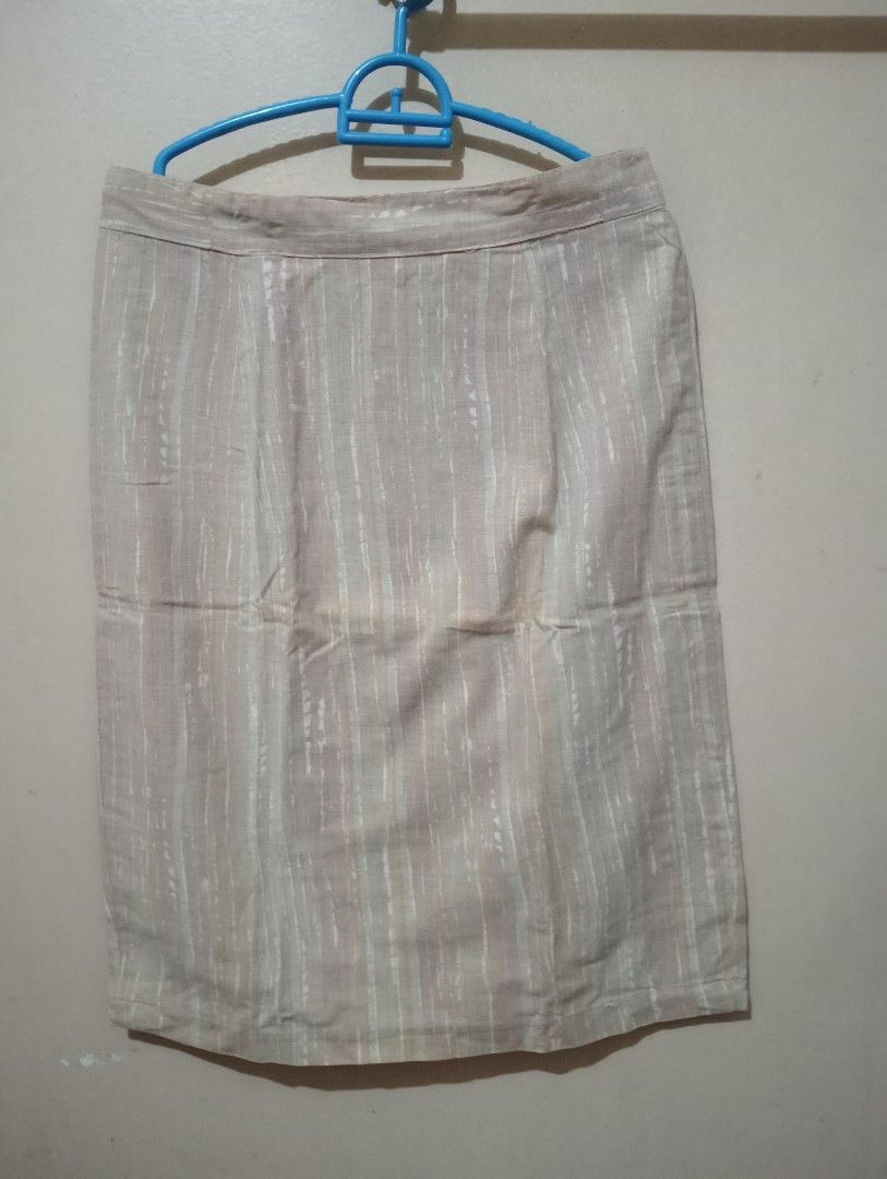 Beige Striped Pencil Skirt with Front Slit (Category: Skirts) located in Makati City. Submitted by YSL80022 (Listing ID 1449250435, Image 1). Description: - Beige pencil skirt - Vertical stripes - Front slit for easy movement - Linen blend look - Versatile for work or casual wear - Simple and classic design - waist: 30 inches - length: 24 inches RFS: weight gain.