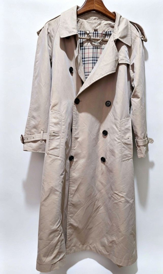 Burberry Classic Beige Trench Coat with Nova Check Lining (Category: Coats, Jackets and Outerwear) located in Naga. Submitted by solamia (Listing ID 1449175371, Image 2). Description: - Classic beige trench coat - Features iconic Nova Check lining - Double-breasted design - Belted waist for adjustable fit - Ideal for layering over any outfit - Timeless and versatile wardrobe staple welcome offers.