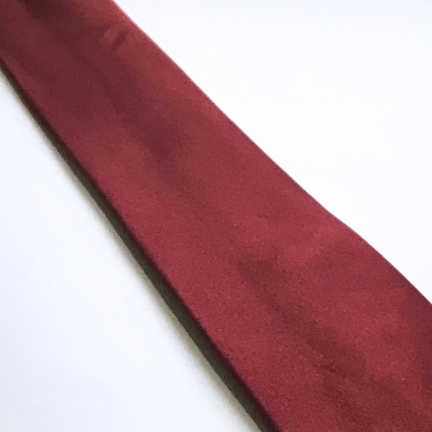 Burma Bibas Plain Burgundy Silk Tie (Category: Ties) located in Taguig. Submitted by retrogaze (Listing ID 1449166071, Image 3). Description: This timeless necktie by Burma Bibas is crafted from 100% premium silk. It features a solid, plain burgundy base with a rich, matte-like texture that catches the light with subtle sophistication. The back is securely finished with a keeper loop and the brand's classic woven label, ensuring both style and du