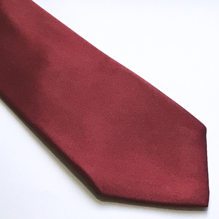 Burma Bibas Plain Burgundy Silk Tie (Category: Ties) located in Taguig. Submitted by retrogaze (Listing ID 1449166071, Image 2). Description: This timeless necktie by Burma Bibas is crafted from 100% premium silk. It features a solid, plain burgundy base with a rich, matte-like texture that catches the light with subtle sophistication. The back is securely finished with a keeper loop and the brand's classic woven label, ensuring both style and du