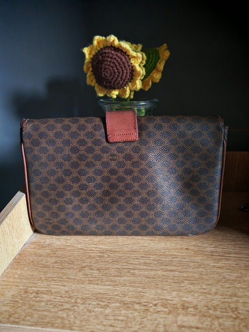 Celine Macadam Pattern Leather Clutch Bag (Category: Luxury Bags & Wallets) located in Manila. Submitted by cleverwhale_45b7bc (Listing ID 1449189593, Image 2). Description: - Authentic Vintage Celine Clutch Bag - Iconic Macadam Pattern - Classic Brown and Tan Colorway - Genuine Leather Trim and Strap Closure - Interior Features Multiple Compartments and a Zippered Pocket - Made in Italy.