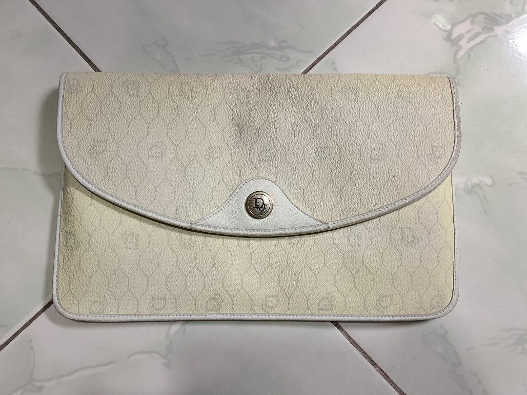 Christian Dior Monogram Pouch Clutch (Category: Luxury Bags & Wallets) located in Manila. Submitted by sheshe.888 (Listing ID 1449169021, Image 1). Description: - vintage Christian Dior pouch - Classic Dior monogram pattern all over - Color: Cream and white - Features button closure - Adorned with a metal Dior logo detail - Made in France - Interior color: Dark grey - Ideal for organizing essentials - preloved.