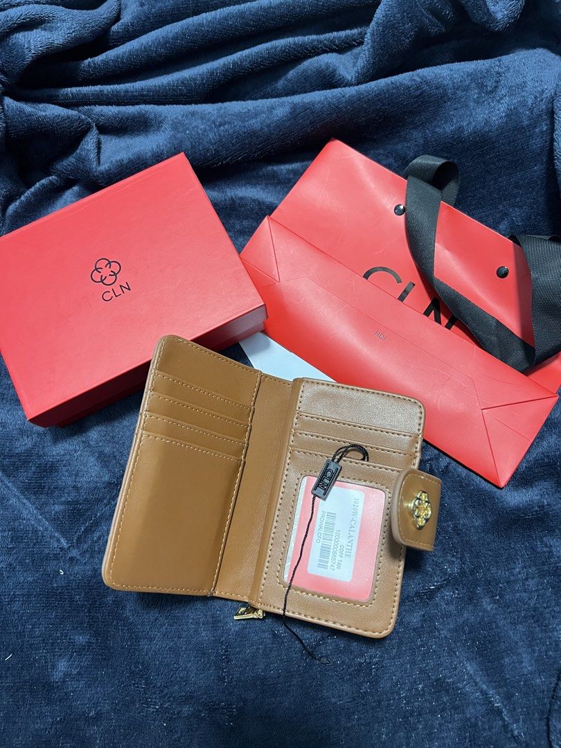 CLN Brown Monogrammed Wallet with Box and Bag (Category: Wallets & Card holders) located in Prosperidad. Submitted by stuffby_deni (Listing ID 1449159164, Image 2). Description: - Brown CLN wallet with signature monogram pattern - Includes original red box and red shopping bag - Tan interior with multiple card slots - Features a dedicated coin compartment - Secure snap closure - Ideal for everyday use.