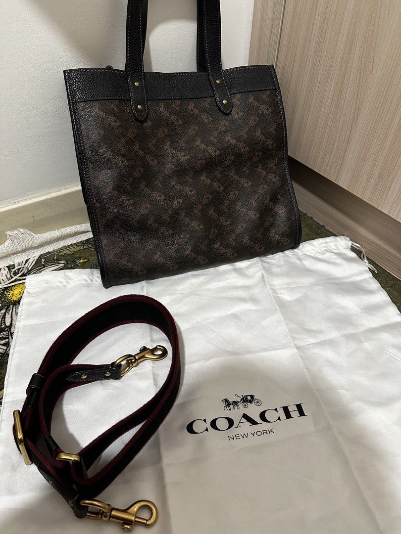 Coach Tote Bag with Strap (Category: Tote Bags) located in Kuala Lumpur. Submitted by kazuha23 (Listing ID 1449248018, Image 2). Description: - Authentic Coach tote bag - Signature horse and carriage print - Black pebbled leather trim and handles - Burgundy fabric lining - Detachable crossbody strap included - Elegant gold hardware - Comes with original dust bag.