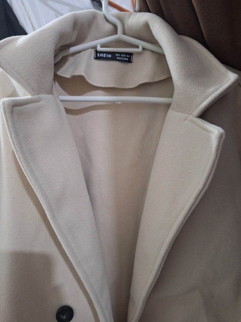 Coat (Category: Coats, Jackets and Outerwear) located in Santa Rosa. Submitted by Jeneceng (Listing ID 1449127447, Image 3). Description: - Brand: EMERY ROSE - Color: Cream - Style: Double-breasted overcoat - Features: Lapel collar, two front pockets, button closure - Season: Ideal for fall and winter layering - Look: Chic and stylish.