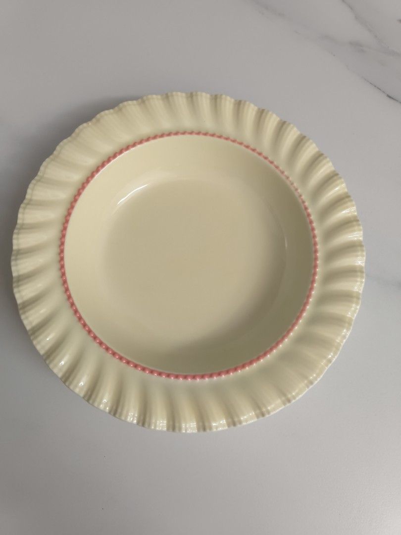 Cream Ceramic Plate Bowl with Pink Trim and Ruffled Edge (Category: Dinnerware & Cutlery) located in Balakong. Submitted by g9i9g9i9 (Listing ID 1449161362, Image 1). Description: - Cream ceramic bowl - Pink beaded trim on inner rim - Ruffled outer edge - Ideal for serving soup or cereal - Doubles as a decorative piece.