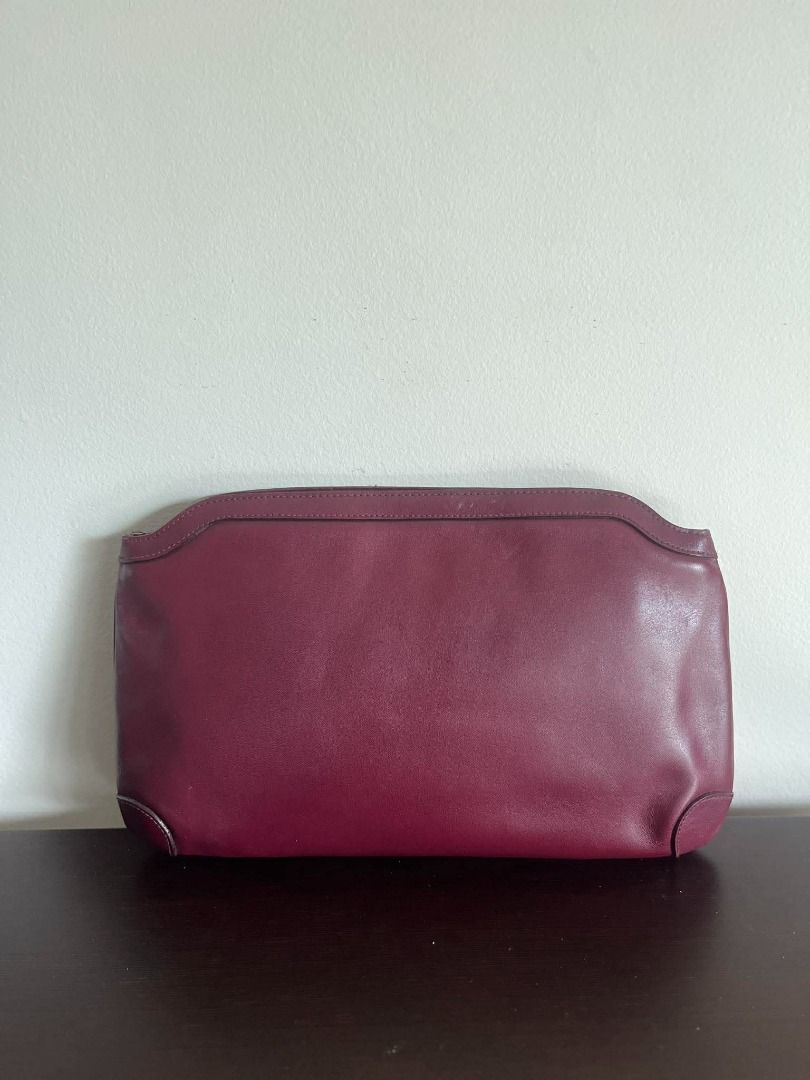 DAKS Burgundy Leather Clutch Bag (Category: Luxury Bags & Wallets) located in Talisay. Submitted by jingcas (Listing ID 1449263239, Image 2). Description: - DAKS Burgundy leather clutch - Classic design with subtle embossed logo - Interior lined with checkered fabric - Features an internal zippered compartment - Ideal for evening events or as a statement accessory.