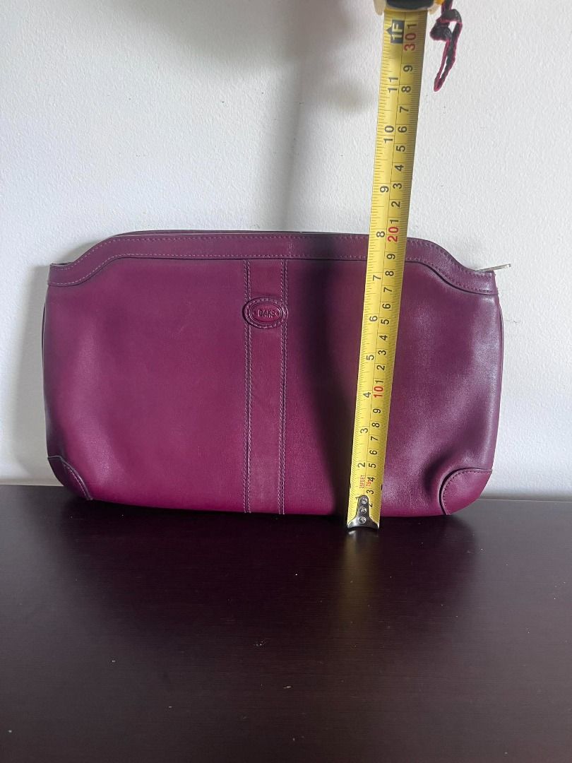 DAKS Burgundy Leather Clutch Bag (Category: Luxury Bags & Wallets) located in Talisay. Submitted by jingcas (Listing ID 1449263239, Image 3). Description: - DAKS Burgundy leather clutch - Classic design with subtle embossed logo - Interior lined with checkered fabric - Features an internal zippered compartment - Ideal for evening events or as a statement accessory.