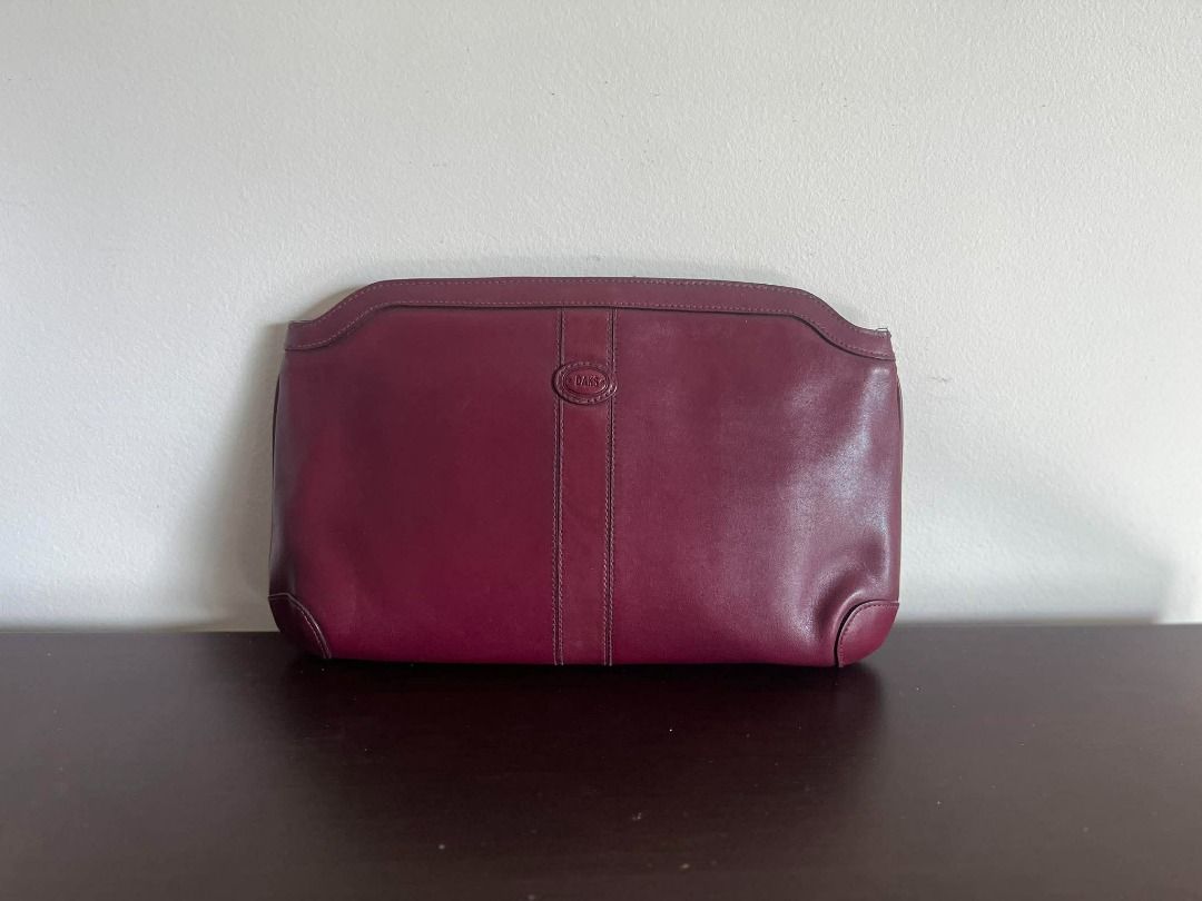 DAKS Burgundy Leather Clutch Bag (Category: Luxury Bags & Wallets) located in Talisay. Submitted by jingcas (Listing ID 1449263239, Image 1). Description: - DAKS Burgundy leather clutch - Classic design with subtle embossed logo - Interior lined with checkered fabric - Features an internal zippered compartment - Ideal for evening events or as a statement accessory.
