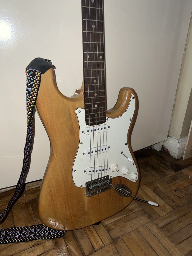 Davis Electric Guitar with Strap (Category: Musical Instruments) located in Makati City. Submitted by shujiscloset (Listing ID 1449204135, Image 2). Description: Davis electric guitar - Natural wood finish - Comes with a patterned strap - Ideal for beginners or as a backup guitar WITH FREE capo, string cleaner, cables Negotiable for serious buyers only.