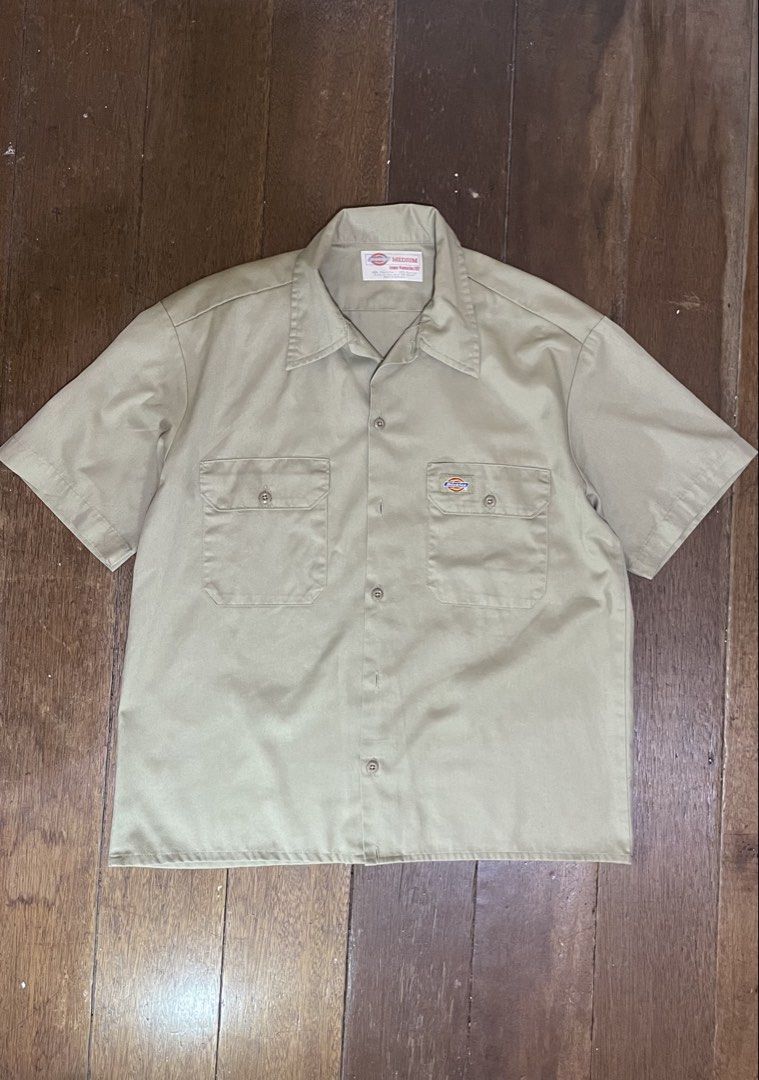 Dickies Cropped Short Sleeve Work Shirt Khaki Medium (Category: Tshirts & Polo Shirts ) located in Quezon City. Submitted by argonlab (Listing ID 1449212920, Image 1). Description: - Classic Cropped Dickies work shirt - Short sleeves, button-up front - Two chest pockets with button closures - Khaki color - Size Medium - Durable fabric - Perfect for work or casual wear - 22Wx26L.
