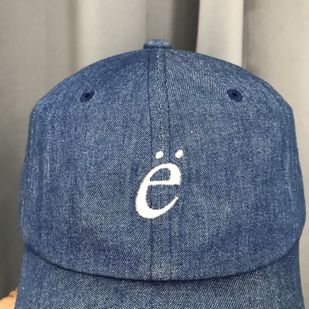 EMIS Denim Baseball Cap with Embroidered 'ë' Logo (Category: Caps & Hats) located in Ozamiz City. Submitted by ClassicDrip (Listing ID 1449245250, Image 3). Description: - Brand: EMIS - Style: Classic blue denim baseball cap - Features: White embroidered 'ë' logo on front, 'emis' on back - Fit: Adjustable strap for a customized fit - Occasion: Perfect for casual wear.