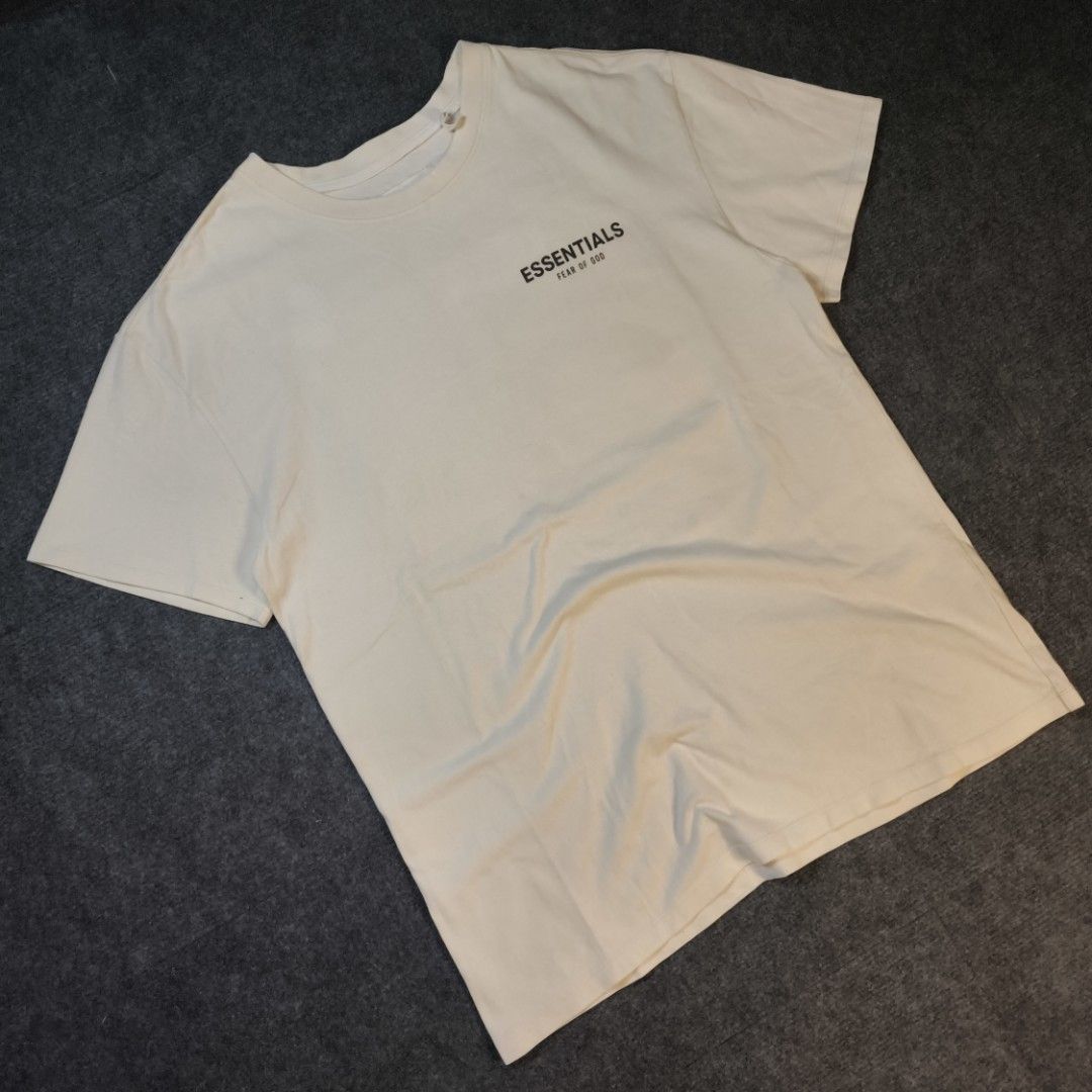 Fear of God Essentials T-Shirt Cream (Category: Tshirts & Polo Shirts ) located in Manila. Submitted by retro_d (Listing ID 1449317536, Image 1). Description: - Cream colored Fear of God Essentials t-shirt - Features the iconic Essentials logo on the chest - Bold graphic print on the back - Classic short sleeves and crew neck design - Comfortable and versatile for everyday styling.