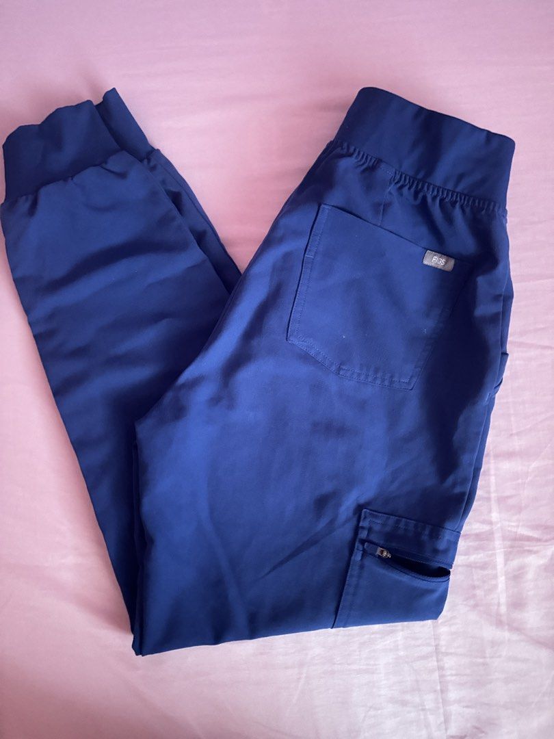 FIGS WINNING BLUE Scrub Top and Jogger Pants Set (Category: Sets or Coordinates) located in Vigan. Submitted by thingsneedtodispose (Listing ID 1449184621, Image 3). Description: - FIGS Scrub Set in Winning Blue - V-neck scrub top with chest pocket - Matching jogger pants - Drawstring waist for adjustable fit - Multiple pockets on pants, including a secure zippered pocket - Comfortable and functional design - Ideal for healthcare professionals - 