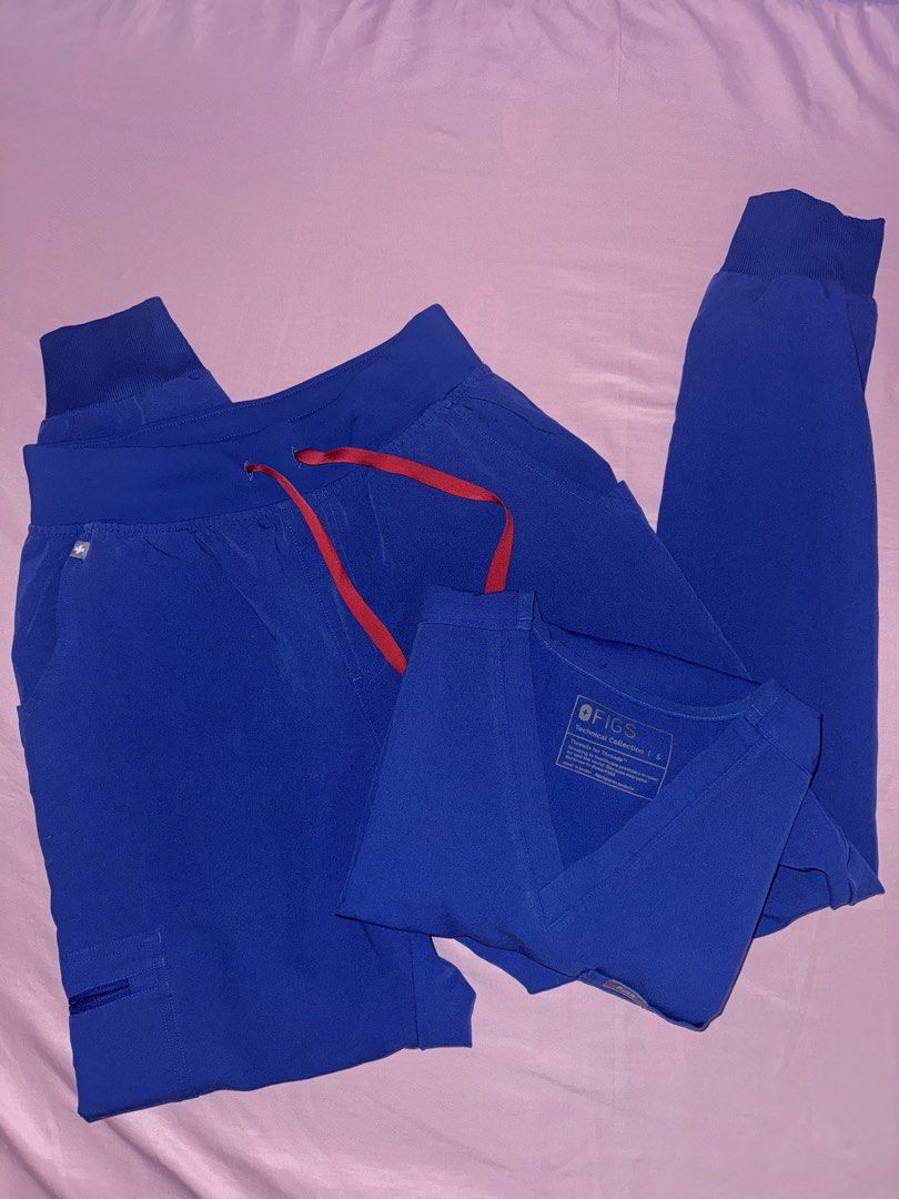 FIGS WINNING BLUE Scrub Top and Jogger Pants Set (Category: Sets or Coordinates) located in Vigan. Submitted by thingsneedtodispose (Listing ID 1449184621, Image 2). Description: - FIGS Scrub Set in Winning Blue - V-neck scrub top with chest pocket - Matching jogger pants - Drawstring waist for adjustable fit - Multiple pockets on pants, including a secure zippered pocket - Comfortable and functional design - Ideal for healthcare professionals - 