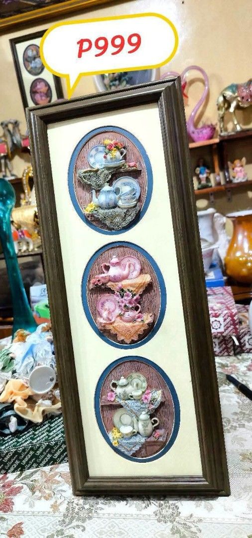 Framed 3D Oval Wall Art with Teacups and Kittens (Category: Wall Decor) located in Quezon City. Submitted by louidanny3 (Listing ID 1449225958, Image 1). Description: - Unique framed wall art with three distinct 3D oval scenes. - Top section: Classic teacups and saucers. - Middle section: Pink teacups and saucers with playful kittens. - Bottom section: Teacups and saucers with a charming cat. - Features a stylish dark brown frame. - Ideal decorat