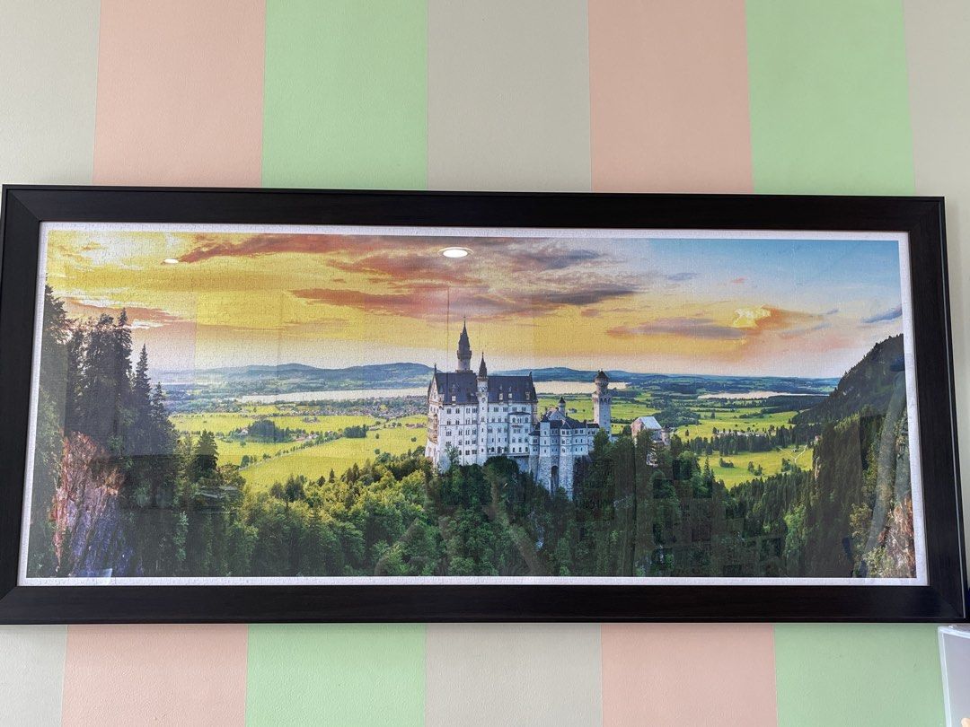 Framed Panoramic Castle Landscape Wall Art (Category: Frames & Pictures) located in Manila. Submitted by phoebe1.23.7 (Listing ID 1449146800, Image 1). Description: 4000 pieces finished puzzle with frame - Large framed artwork featuring a majestic castle at sunset. - Panoramic view with lush green landscape. - Sleek black frame. - Ready to hang, ideal for living rooms, studies, or hallways. - Adds a grand focal point to your wall decor..