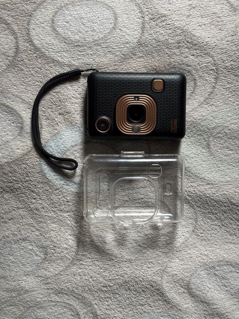 Fujifilm Instax Mini LiPlay Black Instant Camera with Case (Category: Cameras) located in Manila. Submitted by angelujane (Listing ID 1449127991, Image 1). Description: WITH ISSUE NOT TURNING ON - Fujifilm Instax Mini LiPlay camera - Includes clear protective case - Lens has some dust/scratches (refer to close-up photo).