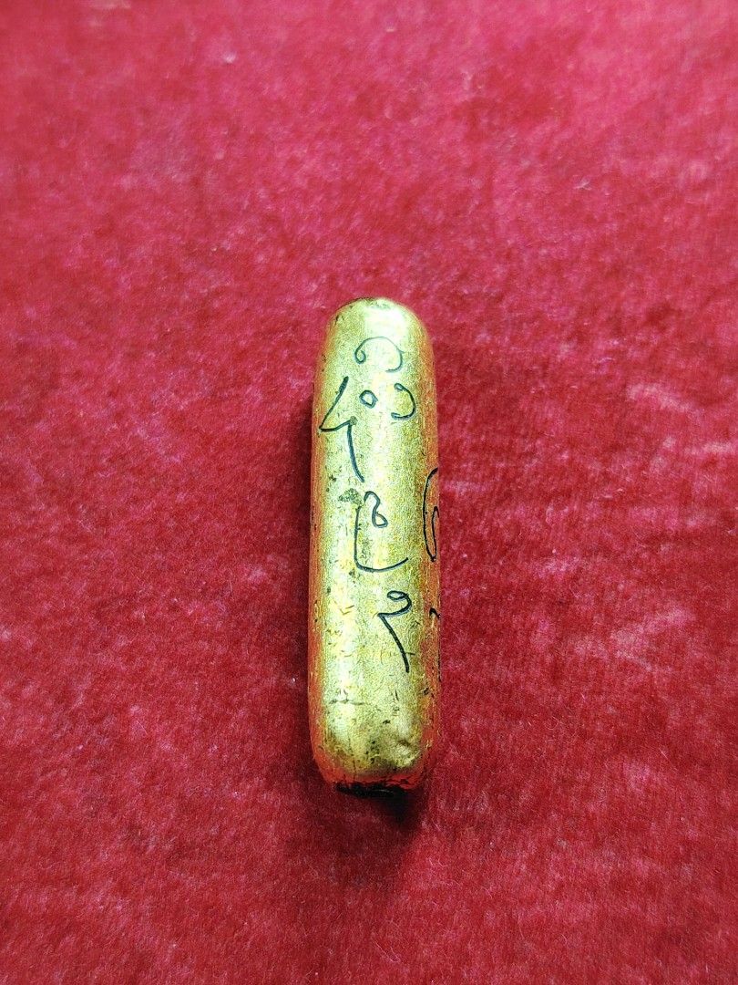 Gold Amulet with Sacred Script (Category: Religious Items) located in Kuala Lumpur. Submitted by feiseang99 (Listing ID 1449114916, Image 1). Description: - Small gold amulet, approximately 2.5cm in size. - Features intricate, handwritten script for a unique touch. - Believed to be a protective charm. - Originates from a monastic setting. - Perfect for collectors or those Takrut Salika sp powder . hand made write yant gold foil Kruba thakun WAT m