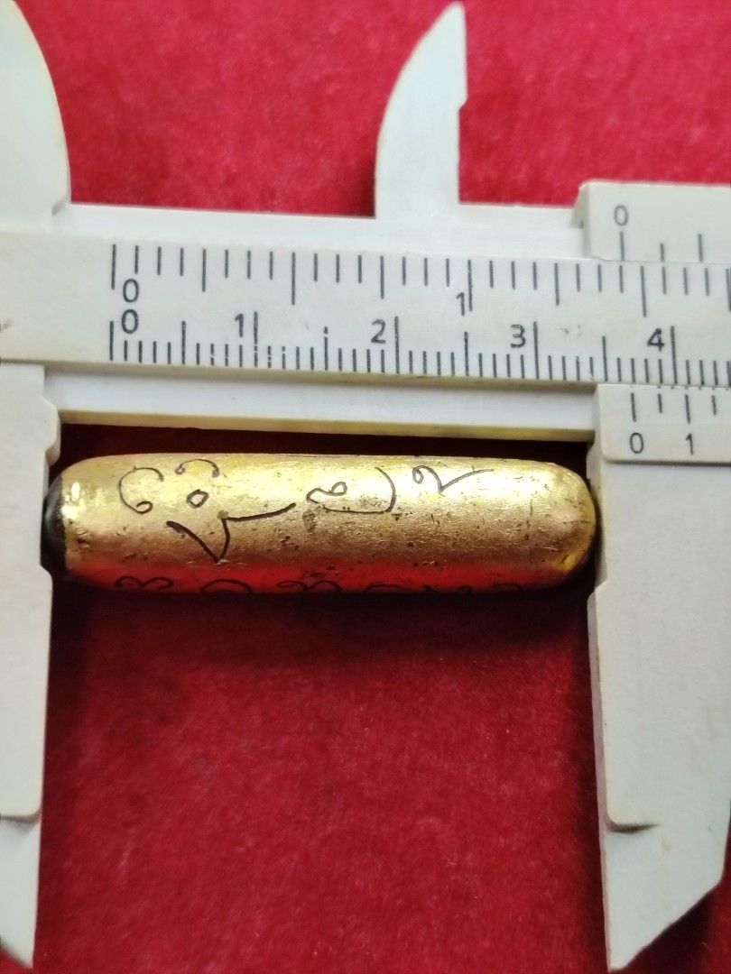 Gold Amulet with Sacred Script (Category: Religious Items) located in Kuala Lumpur. Submitted by feiseang99 (Listing ID 1449114916, Image 3). Description: - Small gold amulet, approximately 2.5cm in size. - Features intricate, handwritten script for a unique touch. - Believed to be a protective charm. - Originates from a monastic setting. - Perfect for collectors or those Takrut Salika sp powder . hand made write yant gold foil Kruba thakun WAT m