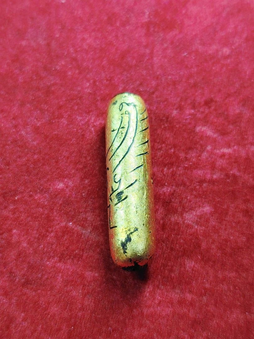 Gold Amulet with Sacred Script (Category: Religious Items) located in Kuala Lumpur. Submitted by feiseang99 (Listing ID 1449114916, Image 2). Description: - Small gold amulet, approximately 2.5cm in size. - Features intricate, handwritten script for a unique touch. - Believed to be a protective charm. - Originates from a monastic setting. - Perfect for collectors or those Takrut Salika sp powder . hand made write yant gold foil Kruba thakun WAT m