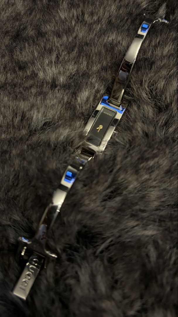 Gucci 3000L Watch Bangle Strap (Category: Luxury Watches) located in Paranaque City. Submitted by preamata (Listing ID 1449208236, Image 1). Description: - Authentic Gucci 3900L Watch - Elegant silver-tone case with a classic black dial - Features a subtle gold ribbon detail on the dial - Band showcases the iconic Gucci logo - Precision Swiss movement - Note: Minor scratches present on the band and clasp Pre-loved. Authentic. Unit only. ***For ba