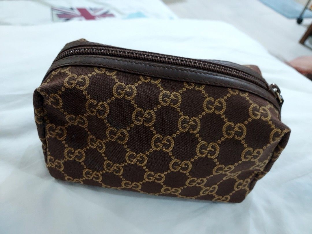 Gucci GG Monogram Cosmetic Bag Pouch Brown (Category: Luxury Bags & Wallets) located in Paranaque City. Submitted by andim8 (Listing ID 1449201933, Image 1). Description: - Authentic Gucci cosmetic pouch - Classic GG monogram pattern - Durable leather trim - Secure zipper closure - Ideal for organizing makeup and small essentials - Compact and portable design medium size.
