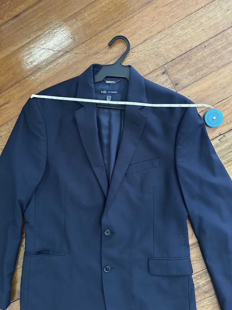 H E by MANGO Navy Blue Two-Button Blazer (Category: Coats, Jackets and Outerwear) located in Pasig City. Submitted by carouselitems (Listing ID 1449147194, Image 3). Description: - Classic navy blue blazer from HE by Mango - Two-button closure - Two front pockets and one chest pocket - Fully lined interior - Versatile for formal or smart casual wear - Measurements available in photos - Please check photos for condition and details - length 31 inc