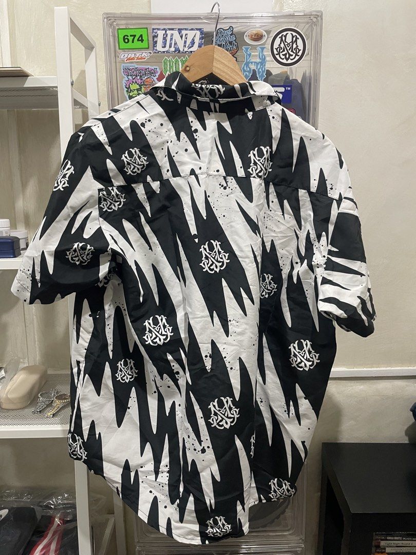 HGHMNDS Polo (Category: Shirts) located in Pasay City. Submitted by slideph (Listing ID 1449186482, Image 3). Description: - Cool black and white graphic print shirt - Short sleeves - Button-up front - Left chest pocket - Unique all-over pattern - Versatile for casual wear or making a statement - Looks good from front and back - Ready for a new owner.