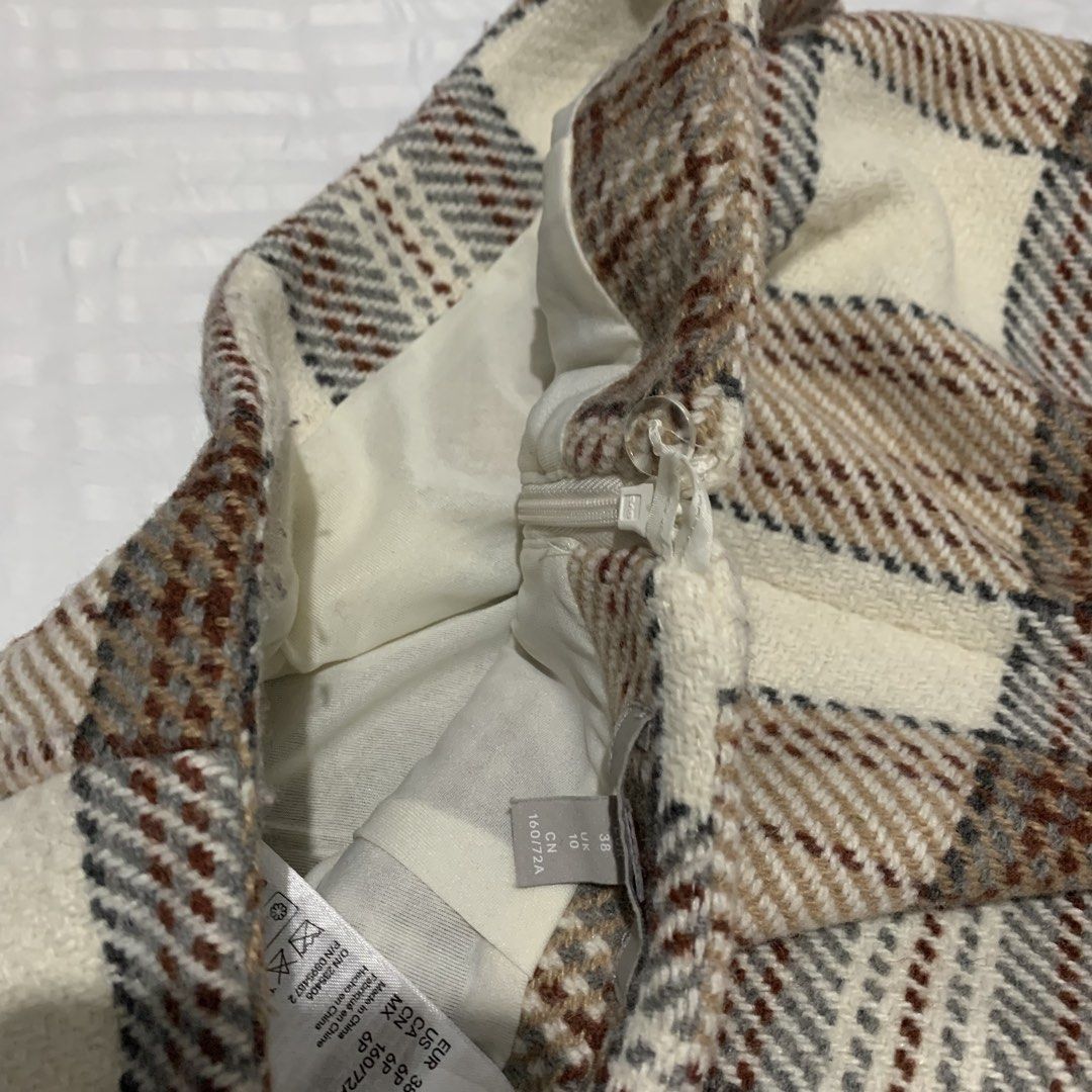 H&M Plaid Wool Mini Skirt (Category: Skirts) located in Mandaluyong City. Submitted by blzstr (Listing ID 1449283624, Image 3). Description: - Cute H&M mini skirt - quality wool material - Cream, brown, and grey plaid pattern - Perfect for fall or winter styling - Size EUR 38 / UK 10 - used twice.