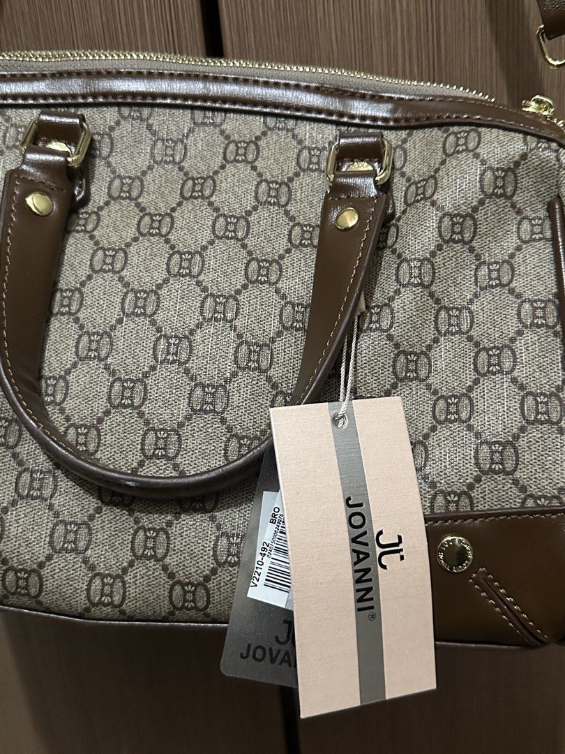 JOVANNI Monogrammed Satchel Bag with Charm (Category: Luxury Bags & Wallets) located in Pasig City. Submitted by theinternetz (Listing ID 1449188552, Image 3). Description: selling this brand new JOVANNI satchel bag purchased from the SM store. it has never been used and still comes with its original tag! specifics: brand: Jovanni condition: brand new with tag color: classic brown and beige pattern with adjustable shoulder strap for a comfortable