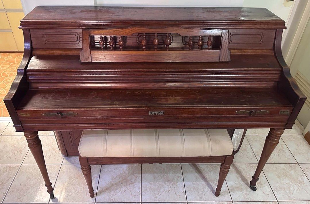 Kimball Upright Piano with Bench (Category: Musical Instruments) located in Quezon City. Submitted by redman04 (Listing ID 1449137680, Image 2). Description: - Vintage Kimball upright piano - Beautiful dark wood finish - Includes matching upholstered bench - Ideal for beginners or as a decorative piece - Shows some wear consistent with age - Keys and pedals are visible -Tuned up recently - Ready for a new home -With flaw (last pic) wood facade/co
