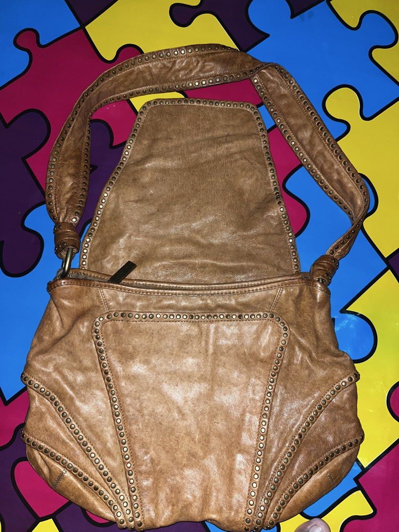 Koba Brown Leather Studded Shoulder Bag (Category: Shoulder Bags) located in Zamboanga. Submitted by xjalilul (Listing ID 1449106151, Image 2). Description: - Brand: Koba - Material: Brown Leather - Style: Shoulder Bag - Features: Studded edges and strap, flap closure - Interior: Zip pocket, slip pocket - Condition: Soft, worn-in leather look - Ideal for: Everyday use.