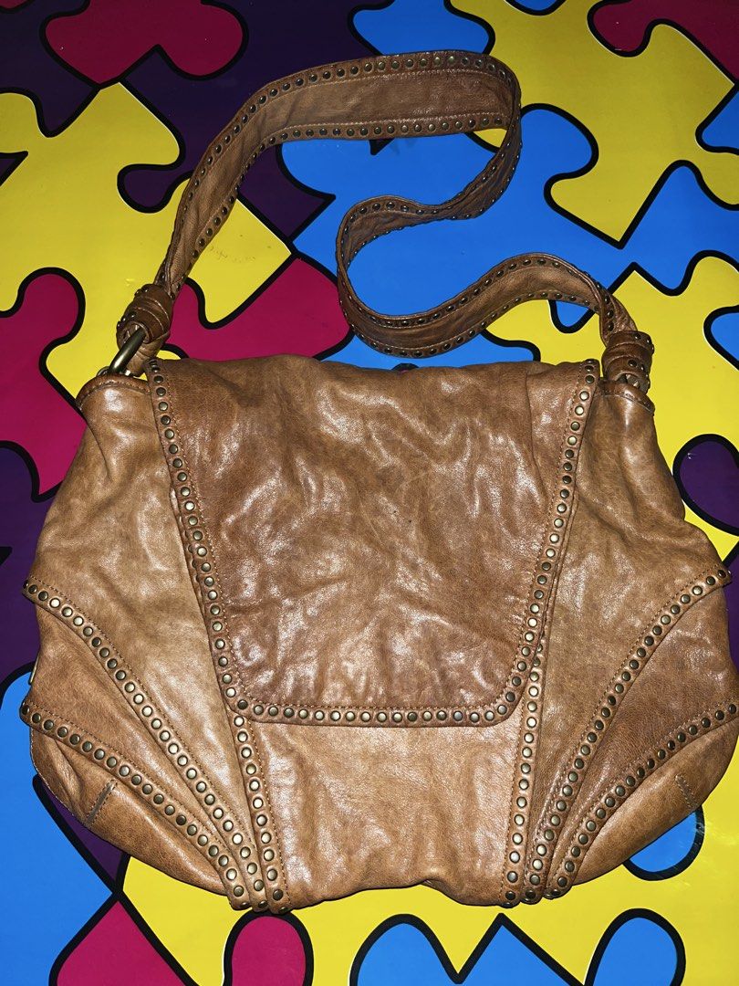 Koba Brown Leather Studded Shoulder Bag (Category: Shoulder Bags) located in Zamboanga. Submitted by xjalilul (Listing ID 1449106151, Image 1). Description: - Brand: Koba - Material: Brown Leather - Style: Shoulder Bag - Features: Studded edges and strap, flap closure - Interior: Zip pocket, slip pocket - Condition: Soft, worn-in leather look - Ideal for: Everyday use.