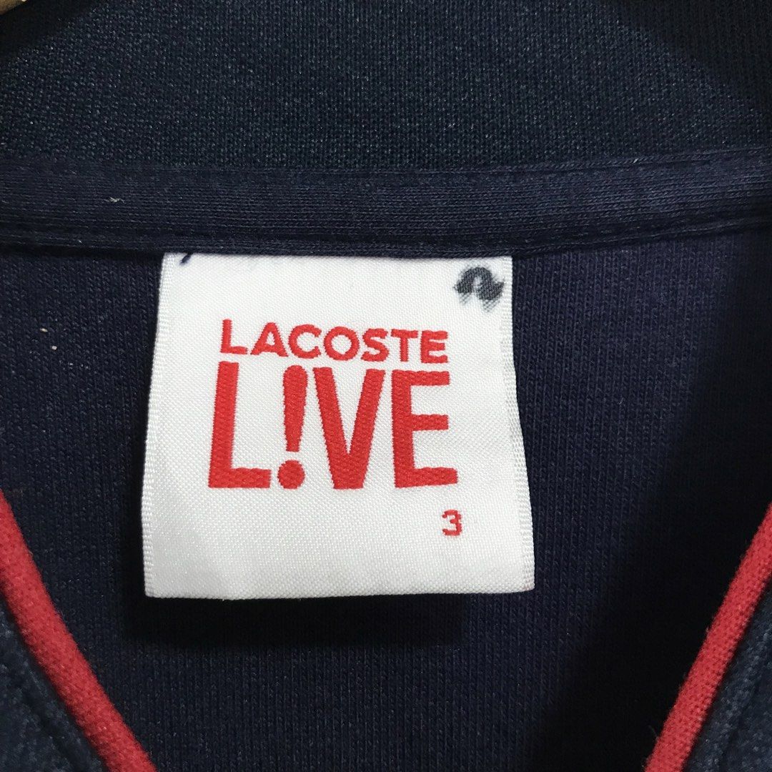 Lacoste Live Navy Bomber Jacket with Red Trim (Category: Coats, Jackets and Outerwear) located in Ozamiz City. Submitted by ClassicDrip (Listing ID 1449241171, Image 3). Description: - Navy blue Lacoste Live bomber jacket - Red trim on zipper and cuffs - Two zip pockets - Size 3 - Made in Vietnam - Cotton blend fabric.