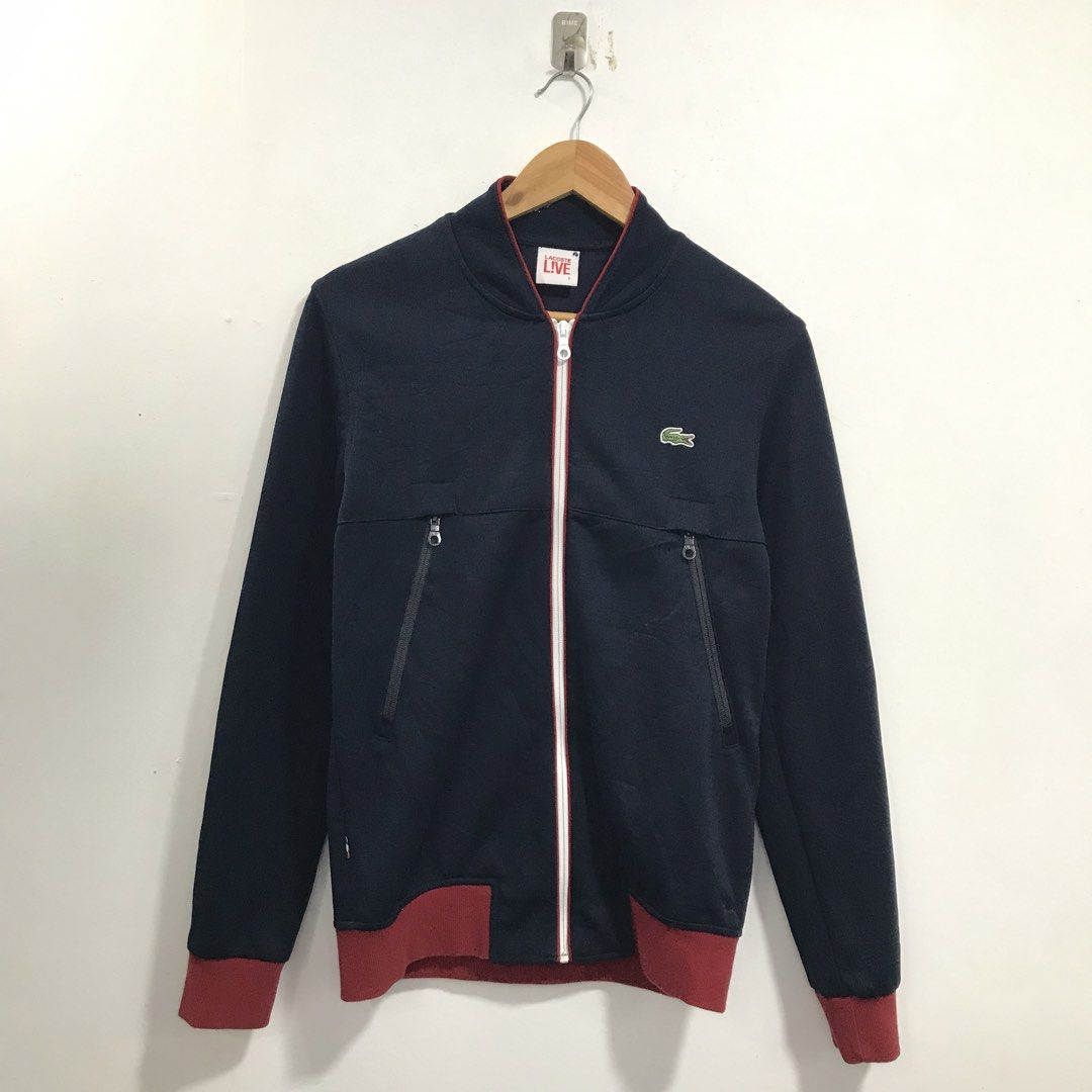 Lacoste Live Navy Bomber Jacket with Red Trim (Category: Coats, Jackets and Outerwear) located in Ozamiz City. Submitted by ClassicDrip (Listing ID 1449241171, Image 1). Description: - Navy blue Lacoste Live bomber jacket - Red trim on zipper and cuffs - Two zip pockets - Size 3 - Made in Vietnam - Cotton blend fabric.