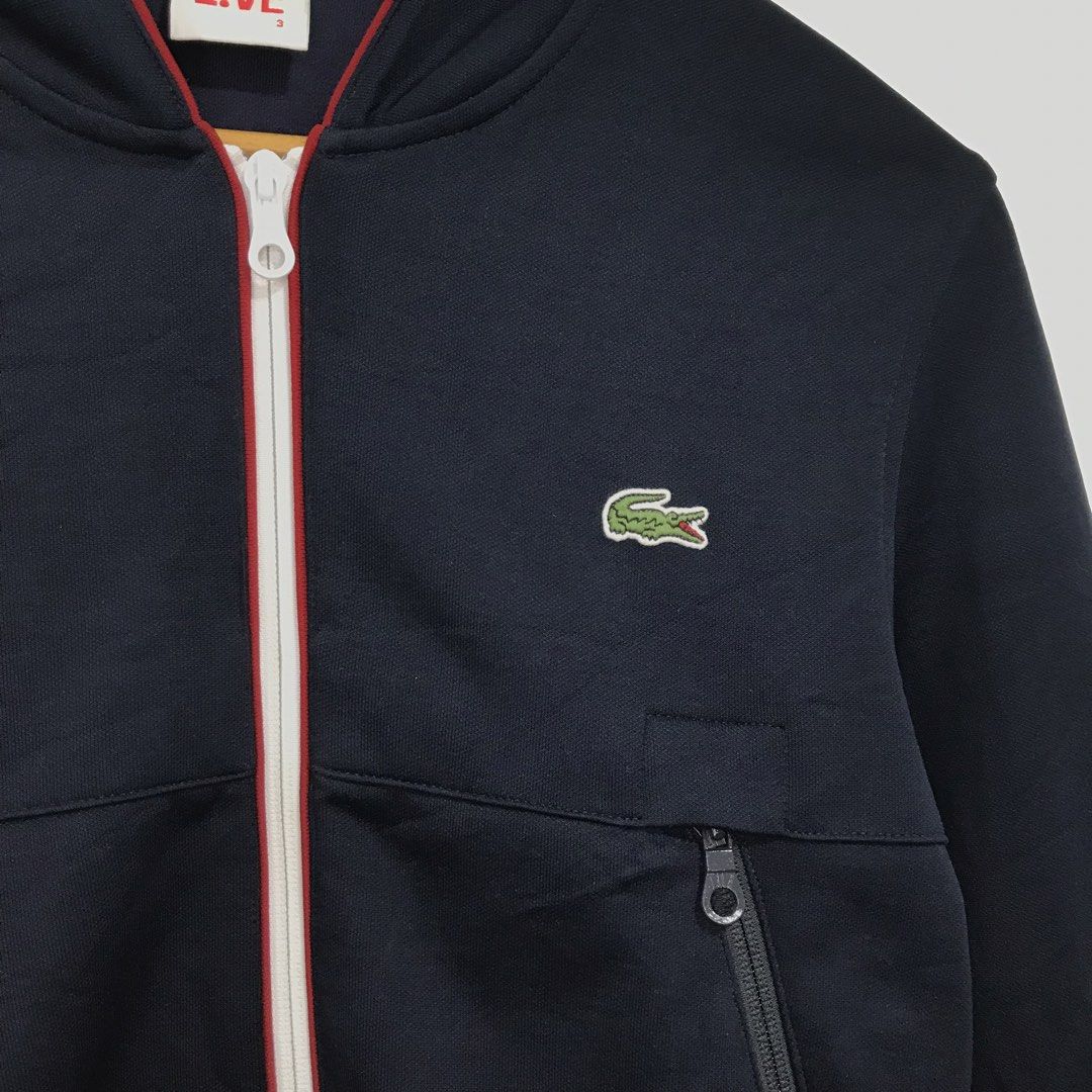 Lacoste Live Navy Bomber Jacket with Red Trim (Category: Coats, Jackets and Outerwear) located in Ozamiz City. Submitted by ClassicDrip (Listing ID 1449241171, Image 2). Description: - Navy blue Lacoste Live bomber jacket - Red trim on zipper and cuffs - Two zip pockets - Size 3 - Made in Vietnam - Cotton blend fabric.