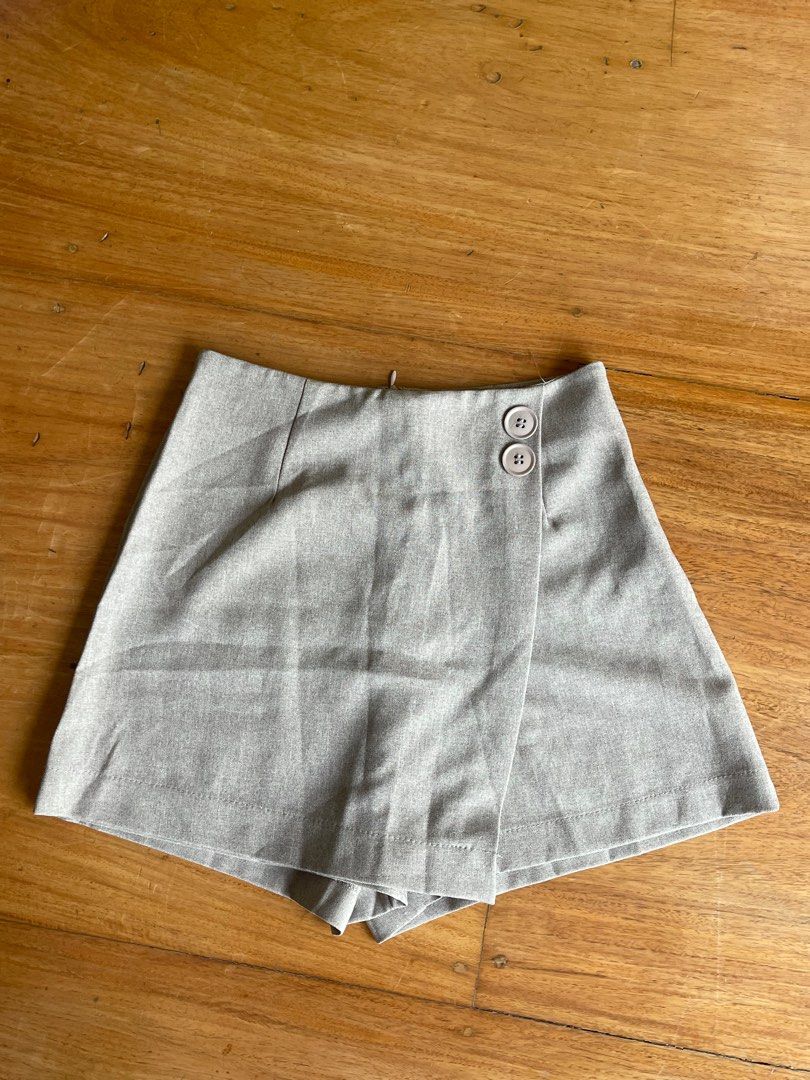 Light Beige High-Waisted Shorts with Double Button Detail (Category: Shorts) located in Makati City. Submitted by jmieiii (Listing ID 1449139903, Image 1). Description: - Light beige color - High-waisted design - Double button closure at the front - Side zipper for easy wear - Tailored fit for a polished look - Versatile for dressing up or down.