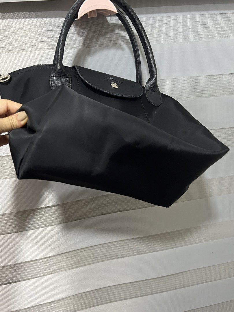 Longchamp Le Pliage Neo Top Handle Bag Black (Category: Luxury Bags & Wallets) located in Las Pinas. Submitted by maple0305 (Listing ID 1449265987, Image 3). Description: - Classic black Longchamp bag - Durable nylon body with leather handles and trim - Secure zipper closure with snap-button flap - Spacious main compartment inside - Ideal for everyday use and easy to carry.