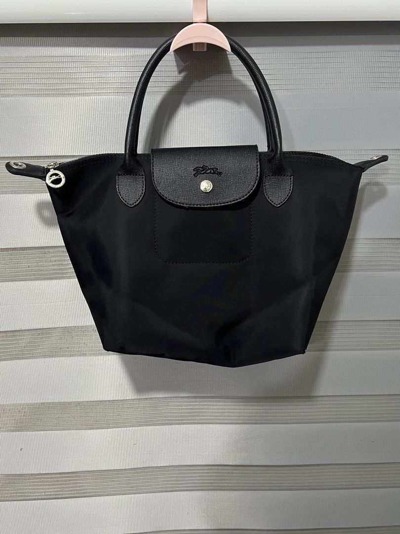Longchamp Le Pliage Neo Top Handle Bag Black (Category: Luxury Bags & Wallets) located in Las Pinas. Submitted by maple0305 (Listing ID 1449265987, Image 1). Description: - Classic black Longchamp bag - Durable nylon body with leather handles and trim - Secure zipper closure with snap-button flap - Spacious main compartment inside - Ideal for everyday use and easy to carry.
