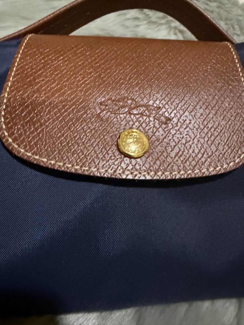 Longchamp Le Pliage Tote Bag Navy Blue (Category: Luxury Bags & Wallets) located in Manila. Submitted by b5l10ilocos (Listing ID 1449185768, Image 2). Description: - Classic Longchamp tote bag - Color: Navy blue nylon with brown leather trim - Closure: Zip with snap button flap - Iconic embossed horse logo on leather - Ideal for everyday use or travel - Folds flat for easy storage.