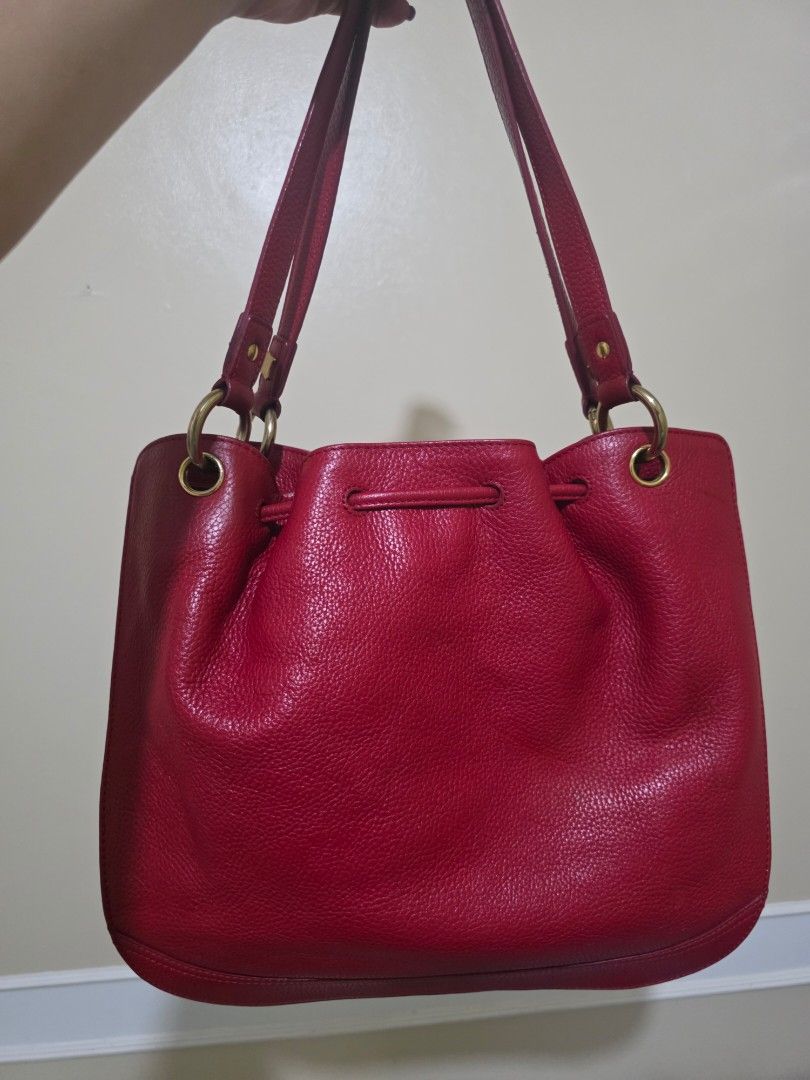 MCM München Red Leather Drawstring Bucket Bag (Category: Luxury Bags & Wallets) located in Las Pinas. Submitted by andthelike (Listing ID 1449251992, Image 2). Description: - Authentic MCM red leather bucket bag - Secure drawstring closure - Elegant gold-tone hardware - Signature MCM logo plate on the front - Two charming red leather tassels with gold caps - Ideal for everyday style and practicality - A timeless MCM classic.